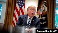 President Donald Trump speaks to members of the media as he meets with members of Congress in the Cabinet Room of the White House, Tuesday, July 17, 2018, in Washington