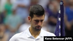 Serbia's Novak Djokovic waits for the trophy ceremony after losing to Russia's Daniil Medvedev during their 2021 US Open Tennis tournament men's final match, September 12, 2021.