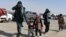 An Afghan migrant family walks in a parking lot before leaving the country in the southwestern province of Nimroz in February. 