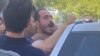 Hossein Ronaghi being detained by security agents in September.