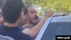 Hossein Ronaghi being detained by security agents in September.