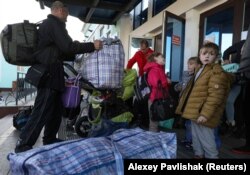 Civili evacuați din regiunea Herson, controlată de ruși, 2 noiembrie 2022.