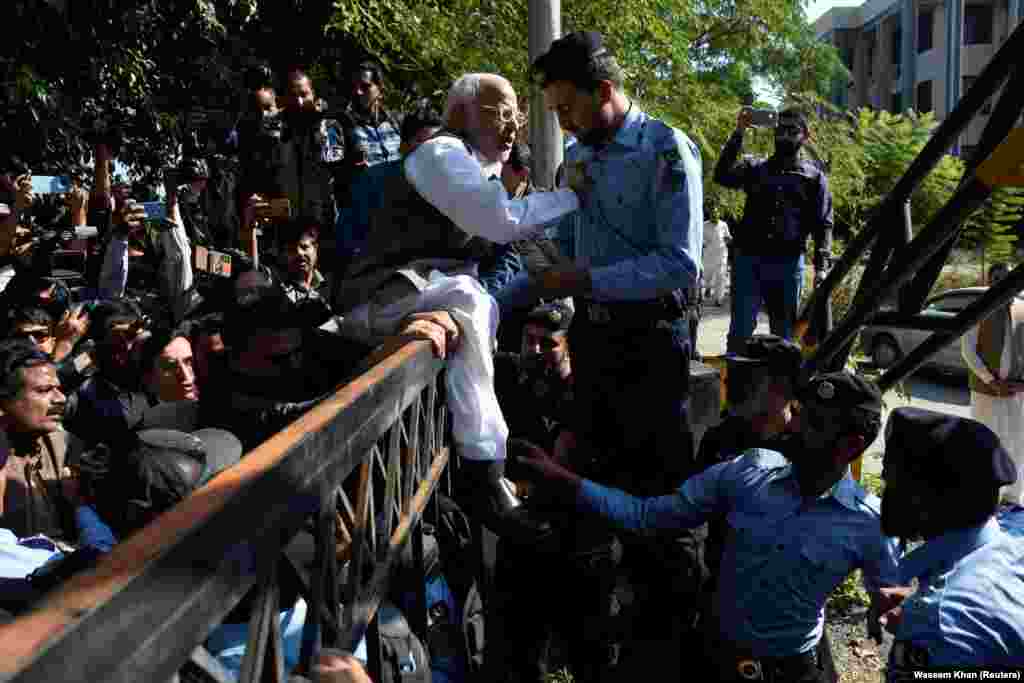 Police officers in Islamabad try to stop angry supporters of the Pakistan Tehreek-e-Insaf political party after Pakistan&#39;s Election Commission barred its leader and former prime minister, Imran Khan, from running in elections for five years as a result of corruption charges.&nbsp;