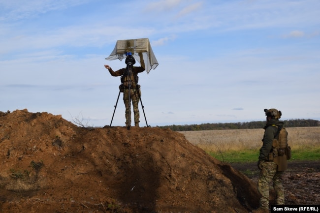 A Ukrainian drone operator known as "Kim" sets up an antenna for controlling a drone in the Kharkiv region on October 22.