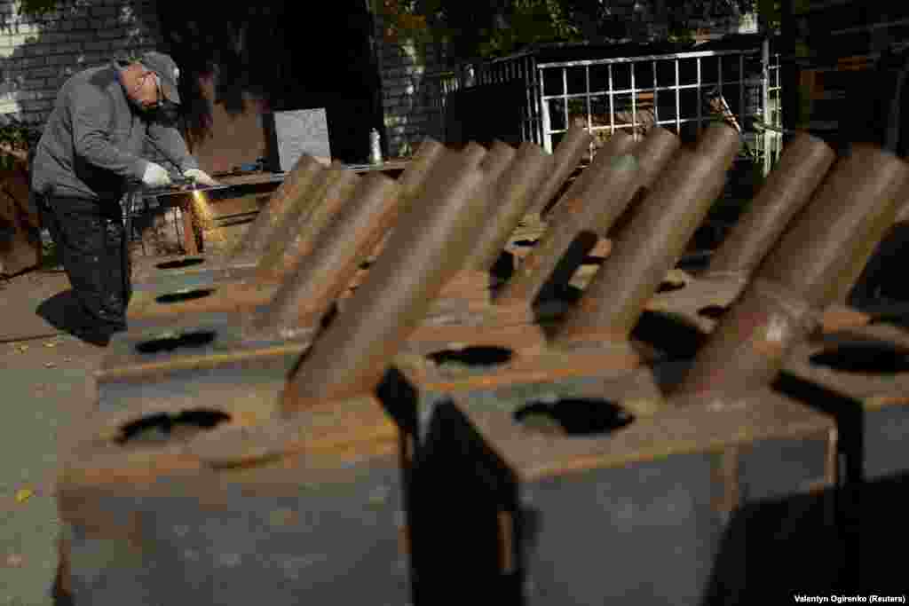 A worker cuts steel used for the wood-burning stoves. The stoves are an initiative led by charities&nbsp;OperationAid&nbsp;and 4UA to counter the impact on civilians of the massive Russian attacks on Ukraine&#39;s energy infrastructure.&nbsp;