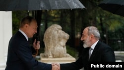 Russian President Vladimir Putin greets Armenian Prime Minister Nikol Pashinian in Sochi, Russia, October 31, 2022.