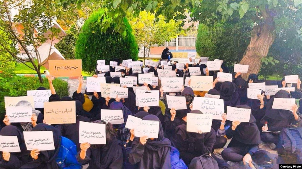 Students at Iran's Al-Zahra University take part in a sit-in protest on October 31 against the suspension of fellow students for taking part in protests that have spread across the country. 