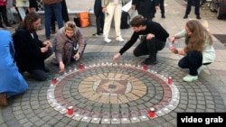 Peace activists from Russia and Ukraine hold a memorial gathering for the victims of Russian totalitarian regimes in Belgrade earlier in October.