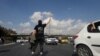 An Iranian protester stands in the highway from Tehran to Karaj on November 3.