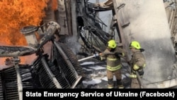 Ukrainian firefighters battle a blaze following a Russia air strike on an energy facility in Rivne on October 22.
