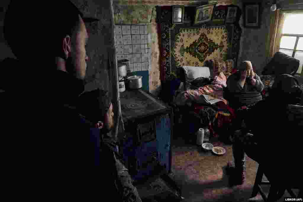 Ukrainian volunteers urge a local elderly woman to leave her house, which is located in a combat zone in the village of Zarechne in the Donetsk region.&nbsp;