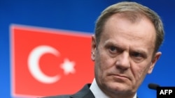 European Council President Donald Tusk addresses a press conference at the end of an EU leaders summit with Turkey centered on the migrant crisis at the European Council in Brussels on March 8.