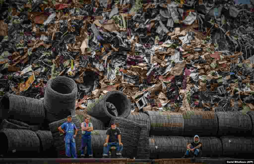 Scrap metal workers stand on a pier in Braila, Romania.