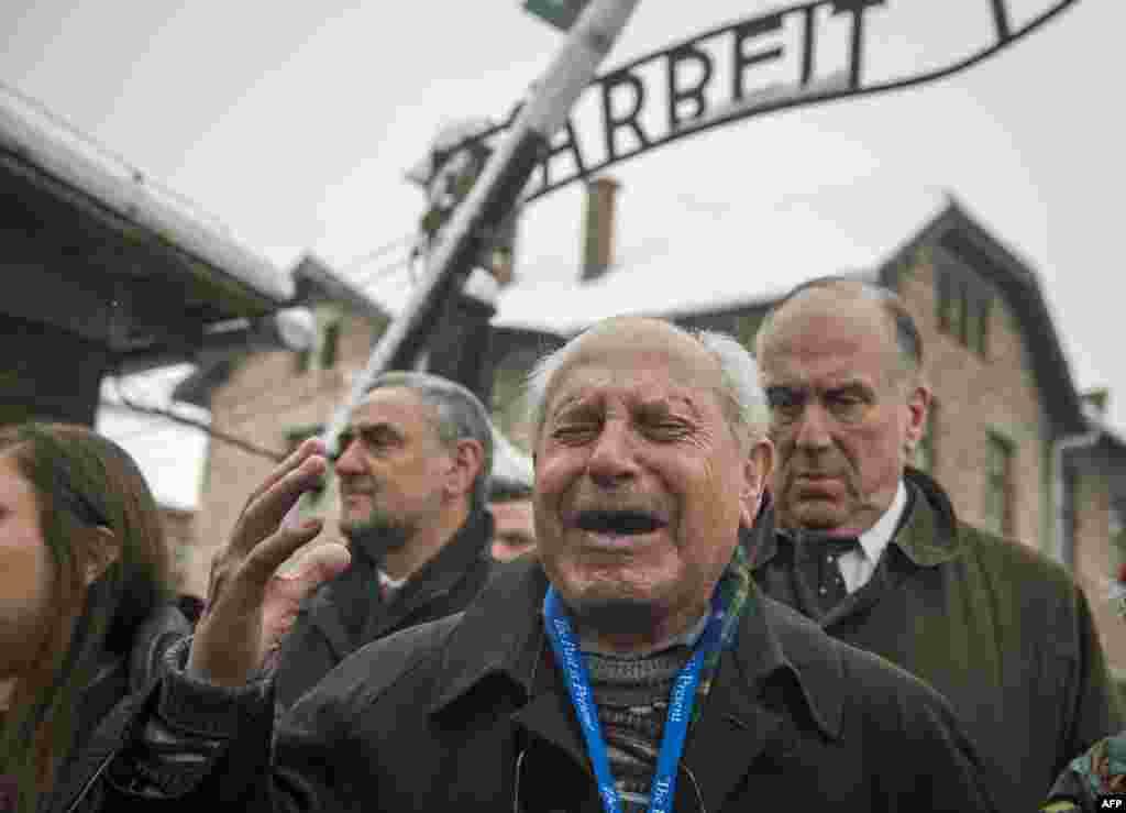 Holocaust survivor Mordechai Ronen is overcome with emotion standing next to the president of the World Jewish Congress, Ronald Lauder (right), as he arrives at the former Auschwitz concentration camp in Oswiecim, Poland, ahead of commemorations marking the 70th anniversary of its liberation.