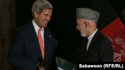 U.S. Secretary of State John Kerry (left) is due to hold talks with Afghan President Hamid Karzai.