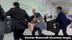 Mammadli is carried away by security guards.