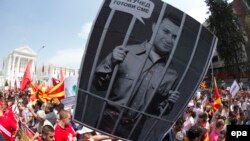 Protestors hold a portrait of Macedonian Prime Minister Nikola Gruevski, depicted behind bars, during an antigovernment rally in Skopje earlier this year. The country has seen months of political turmoil following wiretapping allegations against the premier. 