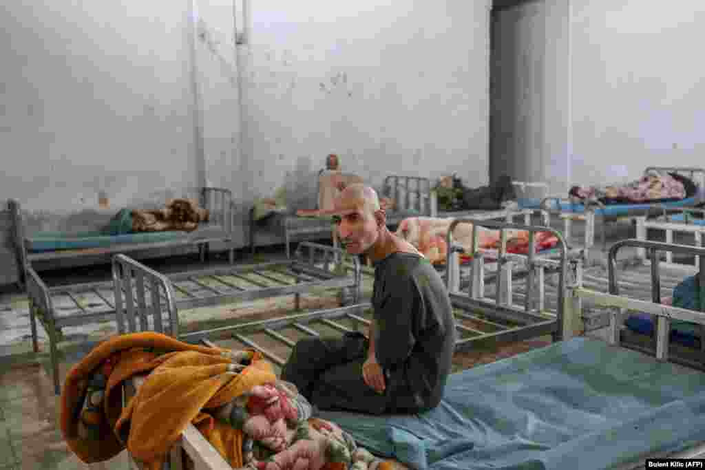 A patient sits on a bed after arriving at a dormitory of the detoxification ward of the Avicenna Medical Hospital for Drug Treatment in Kabul on October 10.&nbsp;