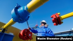 A worker checks a gas valve at the Atamanskaya compressor station, part of Gazprom's Power Of Siberia gas pipeline outside the far eastern town of Svobodny, Russia. 