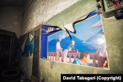 Posters slowly peeling away from the walls of a bomb shelter beneath Tbilisi.