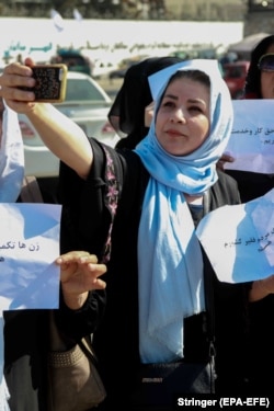 A woman pauses for a selfie during the protest march.