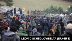 Migrants remonstrate with Polish border guards in Belarus's Hrodno region on November 8. 