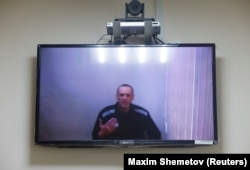 Navalny is seen on a screen via a video link during a hearing in May to consider his lawsuits against the penal colony over detention conditions there.