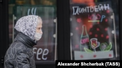 A woman walks in central Moscow amid the surging pandemic. The country will go into a nationwide workplace shutdown in the first week of November in an effort to combat the coronavirus.