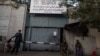 Taliban fighters stand guard at the entrance to the former Ministry of Women Affairs, which the Taliban replaced with the Ministry for the Propagation of Virtue and Prevention of Vice.