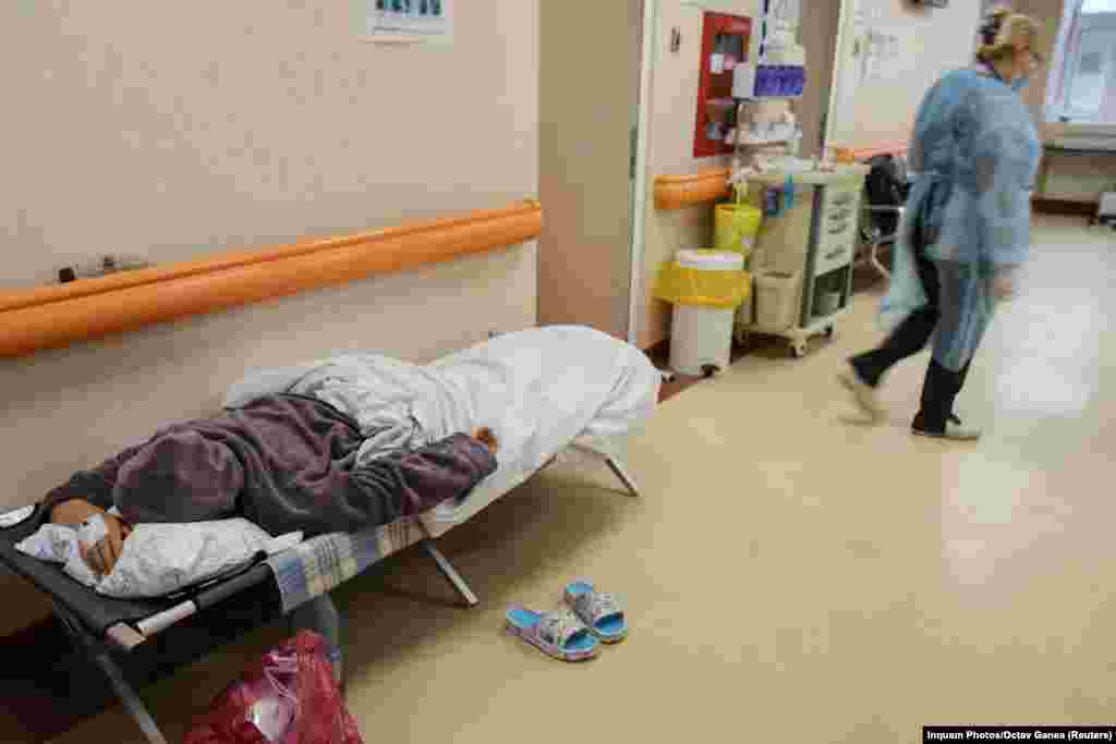 A coronavirus patient lies on a stretcher bed in a hallway of the Matei Bals Institute for Infectious Diseases in Bucharest on October 11.&nbsp;
