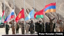 The flags of member countries Tajikistan, Russia, Kyrgyzstan, Kazakhstan, Belarus, and Armenia fly during CSTO training exercises in Tajikistan in 2021.