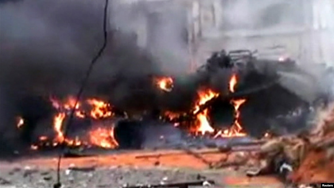 A tank burns, allegedly after being attacked by insurgents from the Free Syrian Army, in the city of Homs on January 12.