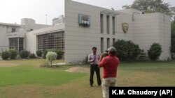 A local news channel crew filming outside the FIFA office in Lahore. (file photo)