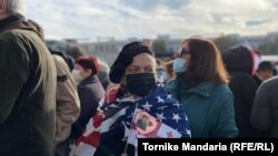 A pro-Saakashvili protester in Tbilisi draped in a U.S. flag (file photo)