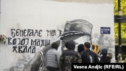 Serbia -- Group of young men are cleaning the street mural of convicted war criminal Ratko Mladic in Belgrade, November 15, 2021.