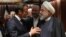 French President Emmanuel Macron (L) and Iranian President Hassan Rouhani speak at the United Nations headquarters on September 23, 2019, in New York. 
