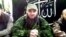 A screen grab of video posted in July 2013 shows Doku Umarov (center) at an undisclosed location. 