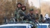 Taliban fighters ride atop a vehicle during a Taliban military parade in Kabul. (file photo)