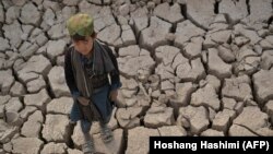 Një djalosh duke qëndruar në tokë të thatë në provincën Bagdis. 15 tetor 2021.
