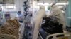 Medical specialists place the body of a person who died of COVID-19 in a body bag at a local hospital in the town of Kalach-on-Don in Russia's Volgograd region on November 14.