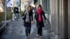 Iranian women walk along a street in Tehran. (file photo)