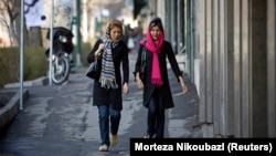 Iranian women walk along a street in Tehran. (file photo)