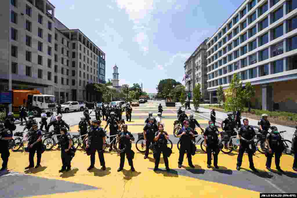 U.S. -- DC Police officers gather on 16th Street outside Lafayette Square the day after protestors attempted to remove a statue of President Andrew Jackson across from the White House in Washington, DC, USA, 23 June 2020. The death of George Floyd in Minn