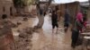 Afghans survey their damaged houses after seasonal floods in Herat on March 29. 