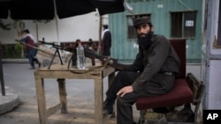 A Taliban soldier holds a machine gun at a checkpoint in Kabul.