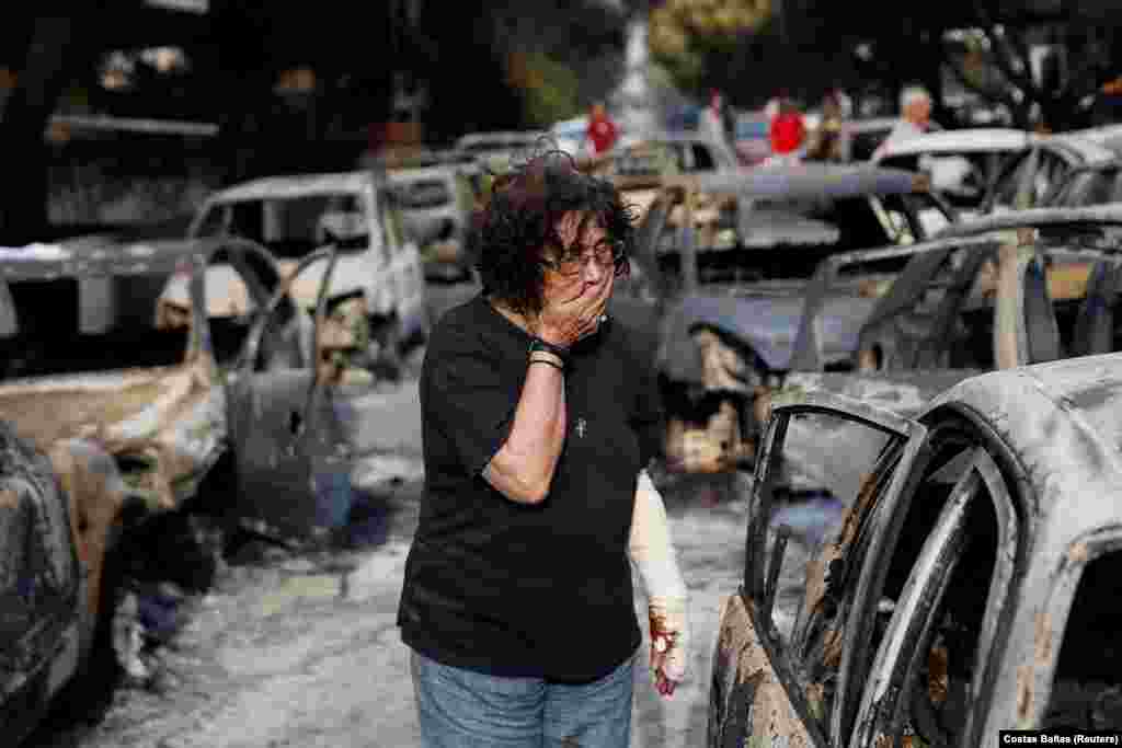 A woman reacts as she tries to find her dog following a wildfire in the village of Mati. At least 60 people have died in wildfires near Athens in the country&#39;s deadliest blazes in more than a decade. (Reuters/Costas Baltas)