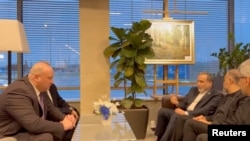 Iranian Foreign Minister Abbas Araqchi talks with officials, according to Iran's media, during his visit to Russia for talks with Russian President Vladimir Putin, in a place given as St. Petersburg, Russia, in a screenshot from video released on April 27.