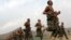 Afghan recruits run in formation at the Afghan National Army Officers' Academy in the Qargha district of Kabul on October 23.