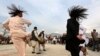 Afghan men perform a traditional "Attan".