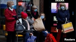 Покупатели в масках на автобусной остановке в Честере, Великобритания, 7 декабря 2020 года